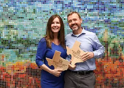 Laura and team with awards