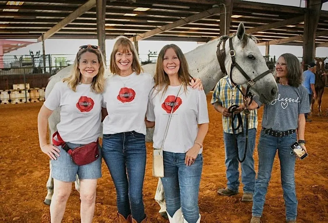 Laura with friends and the therapy horse they support