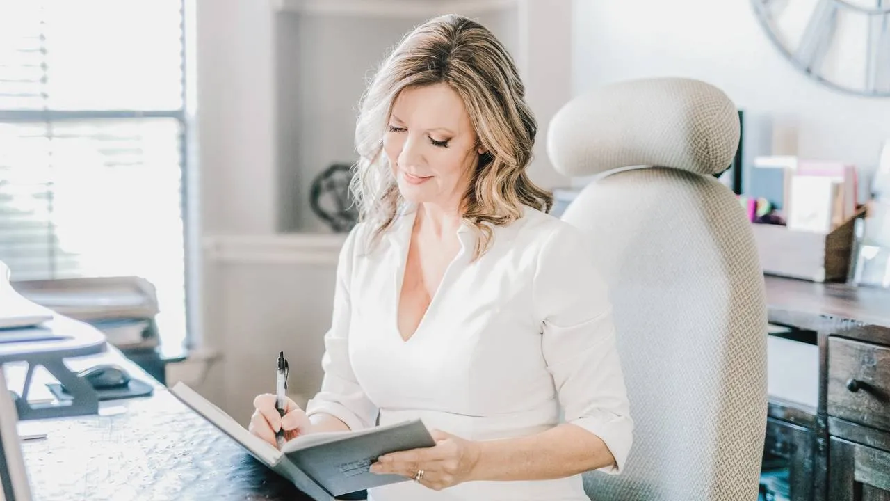 Laura Capes Terry writing at her desk