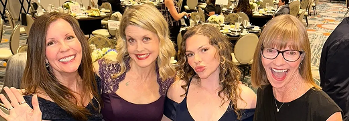 Laura with friends at a gala